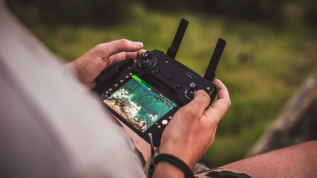 person controlling drone with joystick controller